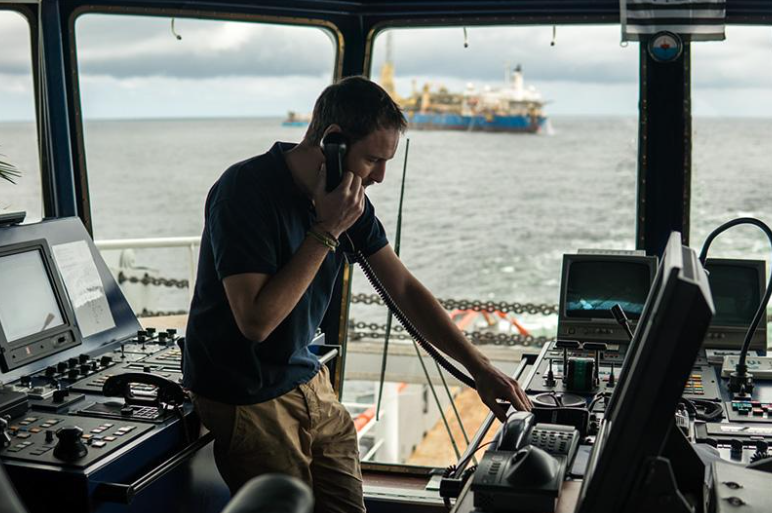 Boat captain using VHF radio to test marine communication
