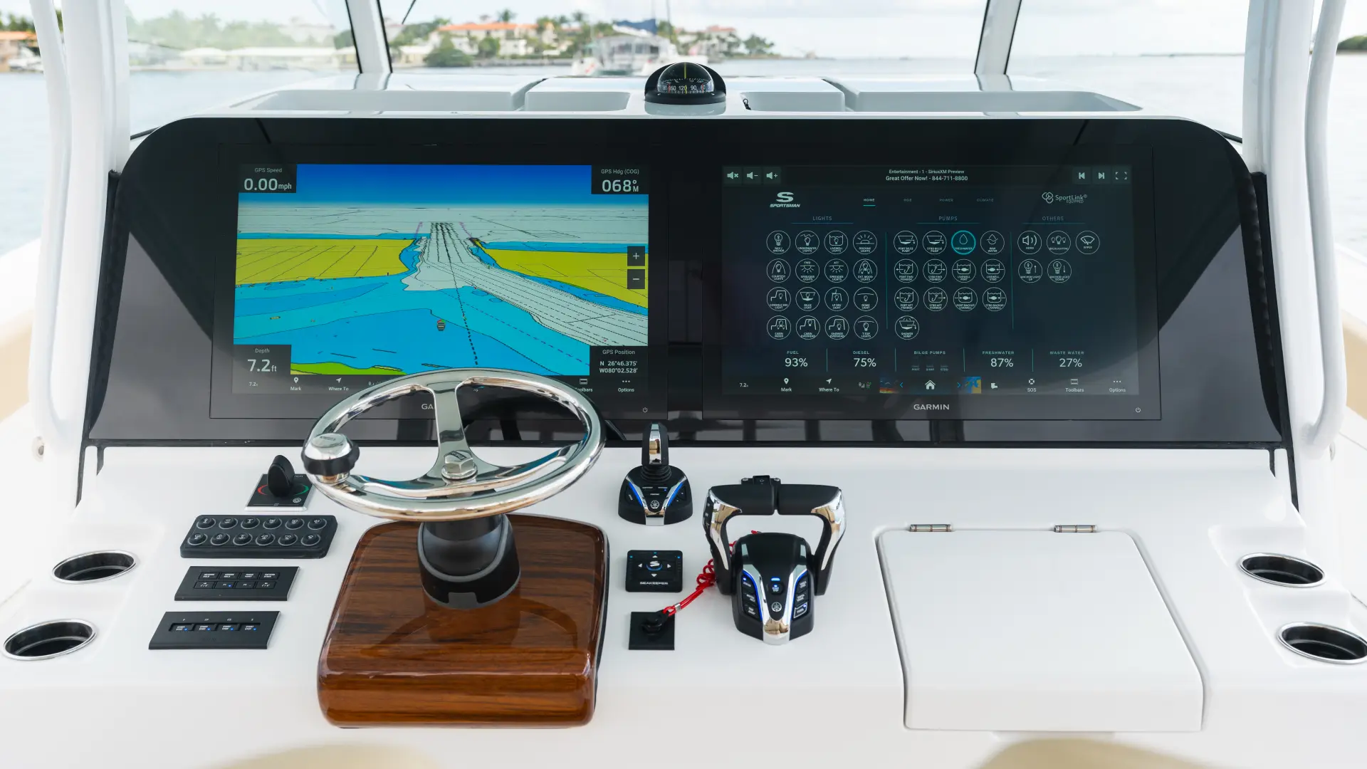 Center-console-boat-helm-featuring-a-large-dual-screen-glass-bridge-navigation-system-